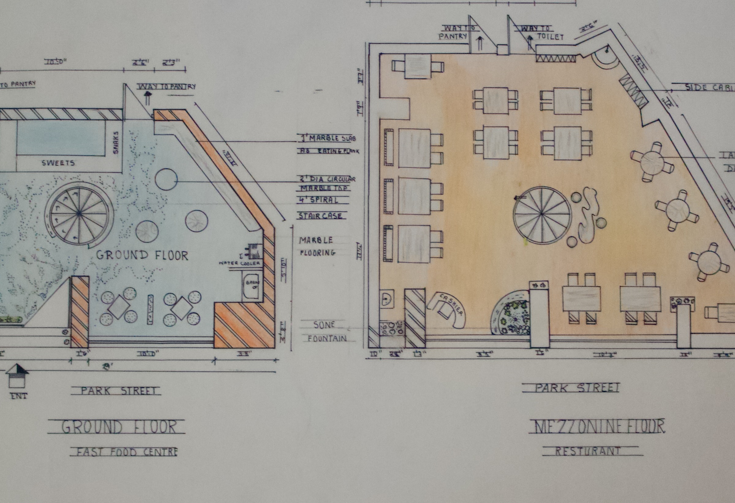Hand-drawn plans for a fast-food center and restaurant showing seating, counters, rooms, and a central spiral staircase.